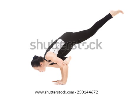 Sporty yoga girl doing fitness training, asana Eka Pada Galavasana, Flying Pigeon (flying crow) Pose, One-Legged Balance, isolated on white background