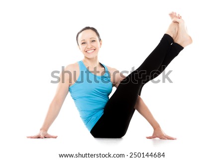 Cheerful sporty yogi girl doing fitness exercises for abdomen, hips, spine, sitting in yoga asana, lifting legs up, isolated on white background