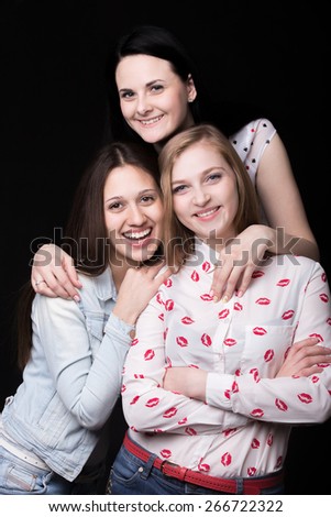 Group photo of three beautiful girlfriends happy smiling together posing in pyramid