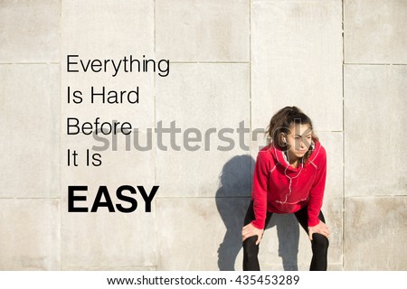 Portrait of young beautiful female leaning on gray background while resting after everyday training. Motivational phrase \