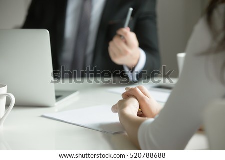 Close up of female hands, nervously clutched. The woman feels stressed, she is scolded by her boss, or is on job interview. Business concept photo