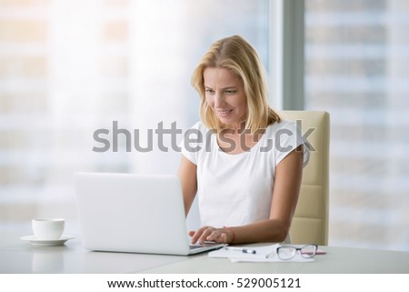 Young attractive woman at a modern office desk, working with laptop, free online classes for interest, stay-at-home mom starting an online business, internet marketing, remote job, lady- blogger