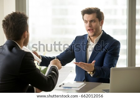 Businessmen arguing at workplace, disagreeing over document, partners having conflict while negotiating, business deal failure, agreement cancelation, breaking contract, unacceptable terms
