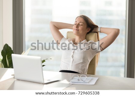 Calm smiling businesswoman relaxing at comfortable office chair hands behind head, happy woman resting in office satisfied after work done, enjoying break with eyes closed, peace of mind, no stress