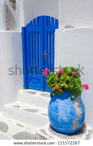 Traditional greek blue gate and white washed house walls