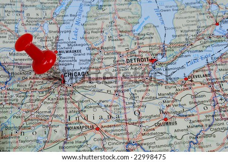 Pin pointing on Chicago on USA map in atlas