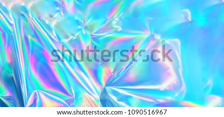 Holographic iridescent surface wrinkled foil pastel. Real Hologram Background of wrinkled abstract foil 80s texture with multiple colors. 90s Blue pastel holographic gradient mesh template surface.