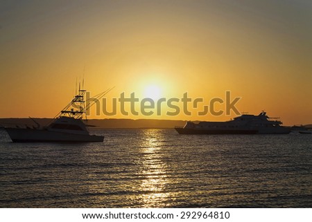the sun rises over the mountain on the Red Sea