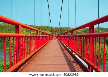 Red bridge in the forest.