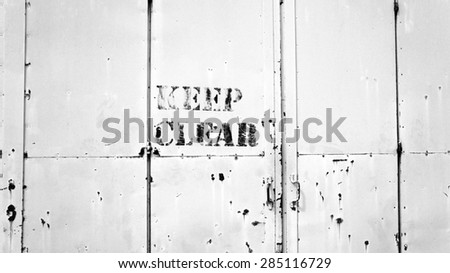 Keep Clear sigh on rusty metal door -  Black & White