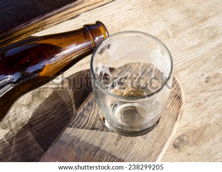 Beer tasting; empty beer bottle and beer flight glass.