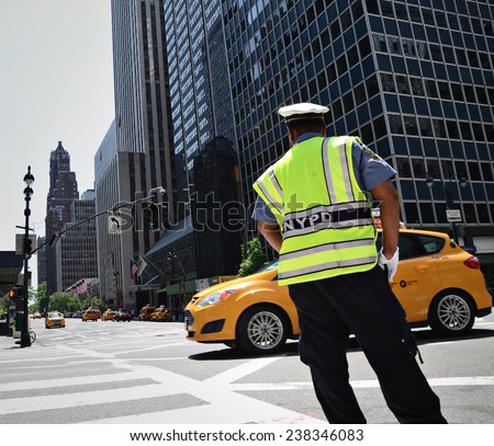 NYPD officer directing traffic in New York City.