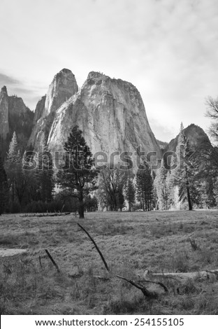 A black and white landscape photograph of a mountain range in Yosemite National Park, taken from the park\'s valley floor.