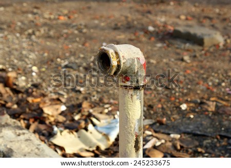 Old, dirty and rusty water pipes after building demolition