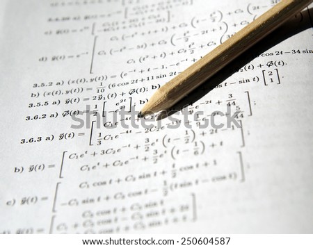 Math study for the exam set (book, pencil, glasses) - Background shows differential equations, derivative and integral