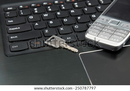 Remote work set: Laptop (notebook) and cell (mobile) phone and security key