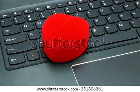 Valentines present and Online / Internet dating subject: Heart shape jewelery box on the laptop keyboard