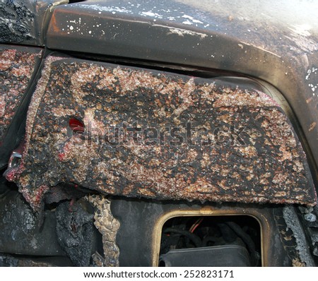 Burn sports car wreck - right rear light (focus on only part of the image intentionally)