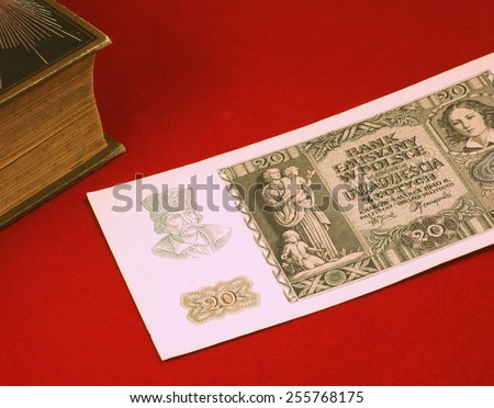Historical, old Polish notes (1919 - 1940), bills on the red carpet background next to old book - classic photo style, focus on some part of the image only.
