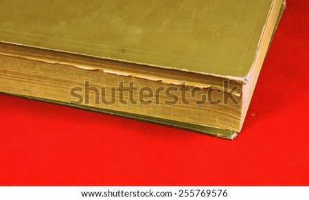 Old (over 100 years) and vintage historical book on the  red carpet background