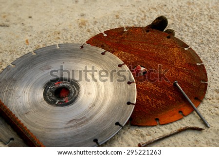 Saw blades on the concrete background