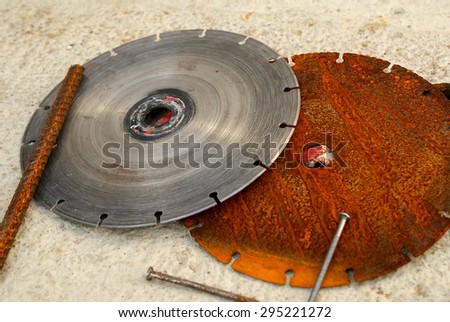 Saw blades on the concrete background