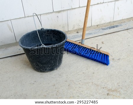 Construction cleaning set: blue broom and black bucket