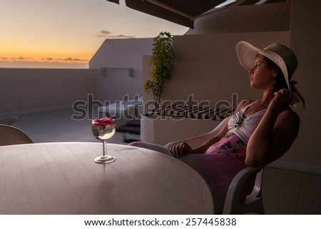 Beautiful girl on the terrace with Bakal wine during sunset. Tenerife Spain