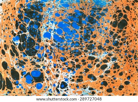 Abstract ebru background with bright orange, blue and dark color spots
