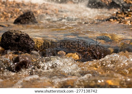 Rocks and water flowing in the community, Ubon Ratchathani, Thailand.