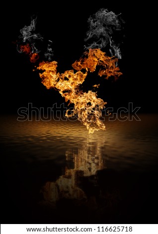 Face silhouettes appearing in blazing fire on top of liquid surface