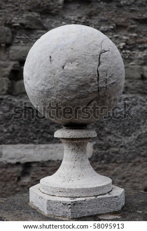 stone sphere on pedestal