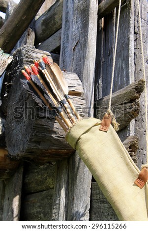 Bow arrows quiver hanging on wood ruins