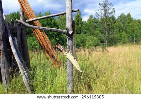 Bow arrows quiver hanging on wood ruins