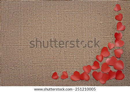 Valentine's day card with red hearts on fabric sack texture background