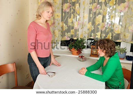 Adult blond woman and young woman at difficult conversation
