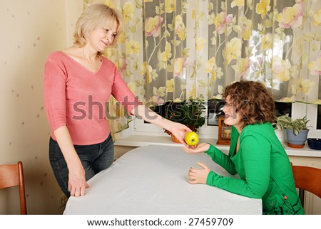 Adult blond woman and young woman at difficult conversation: reconciliation