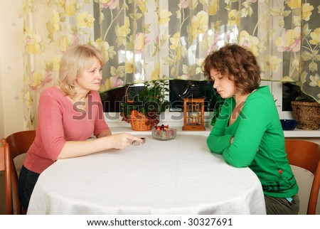 Adult blond woman and young woman at difficult conversation