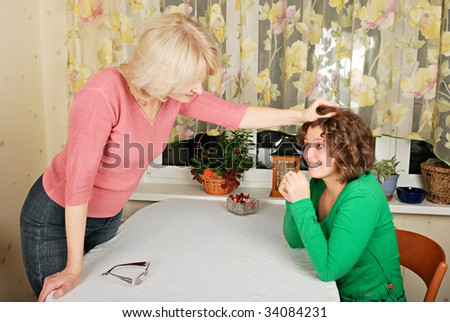 Adult blond woman and young woman jocular punishment