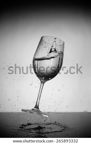 glass and water splash in black and white