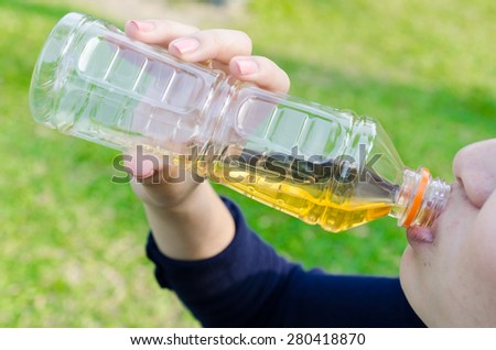 lady drinking a bottle of soft drink