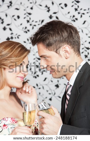 Young couple in love making a toast