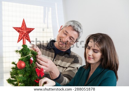 Couple putting together the christmas tree