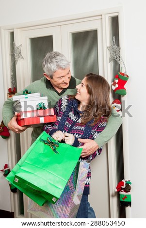 Parents holding gifts for christmas