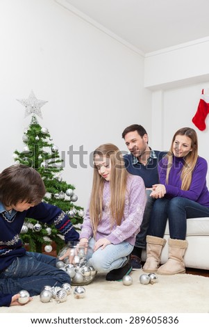 Family preparing the christmas tree