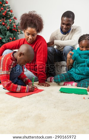 Family together writing the letter to santa