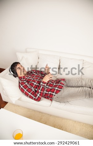 Man listening to music and lying