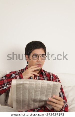 Man reading the newspaper and worried about the news