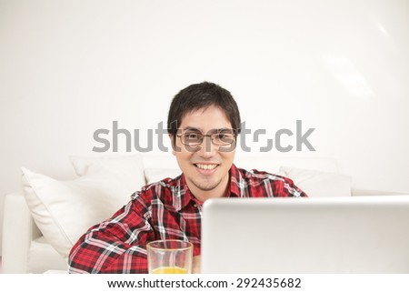 Man using the computer  and looking at camera