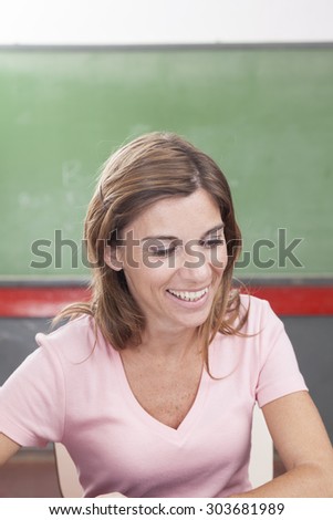 The teacher teaching and smiling